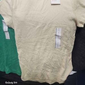 A New Day Casual Short-Sleeve Tee in Pale Yellow and one in green.